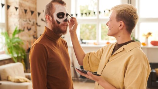 Applying makeup to man