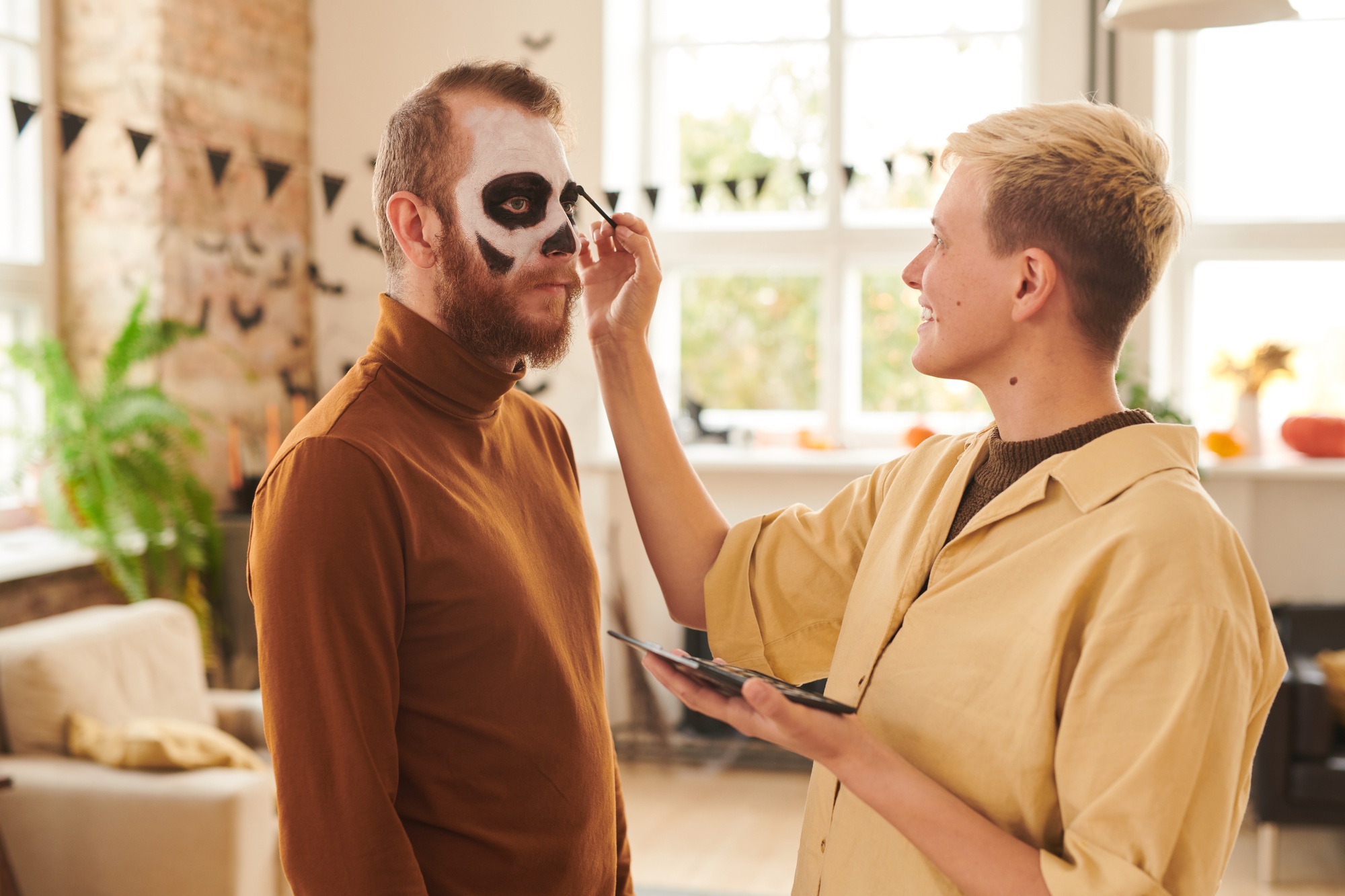 Applying makeup to man