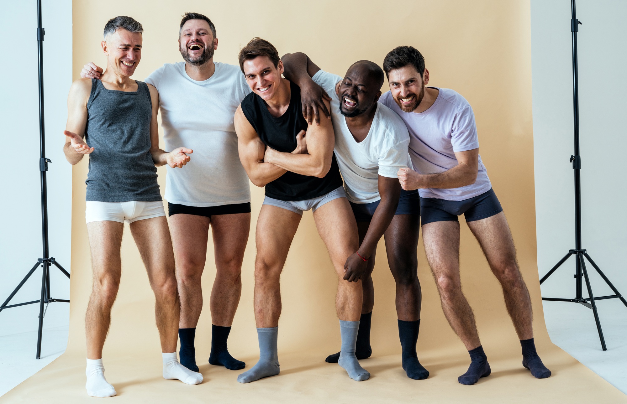 Multiethnic group of men posing for body positive